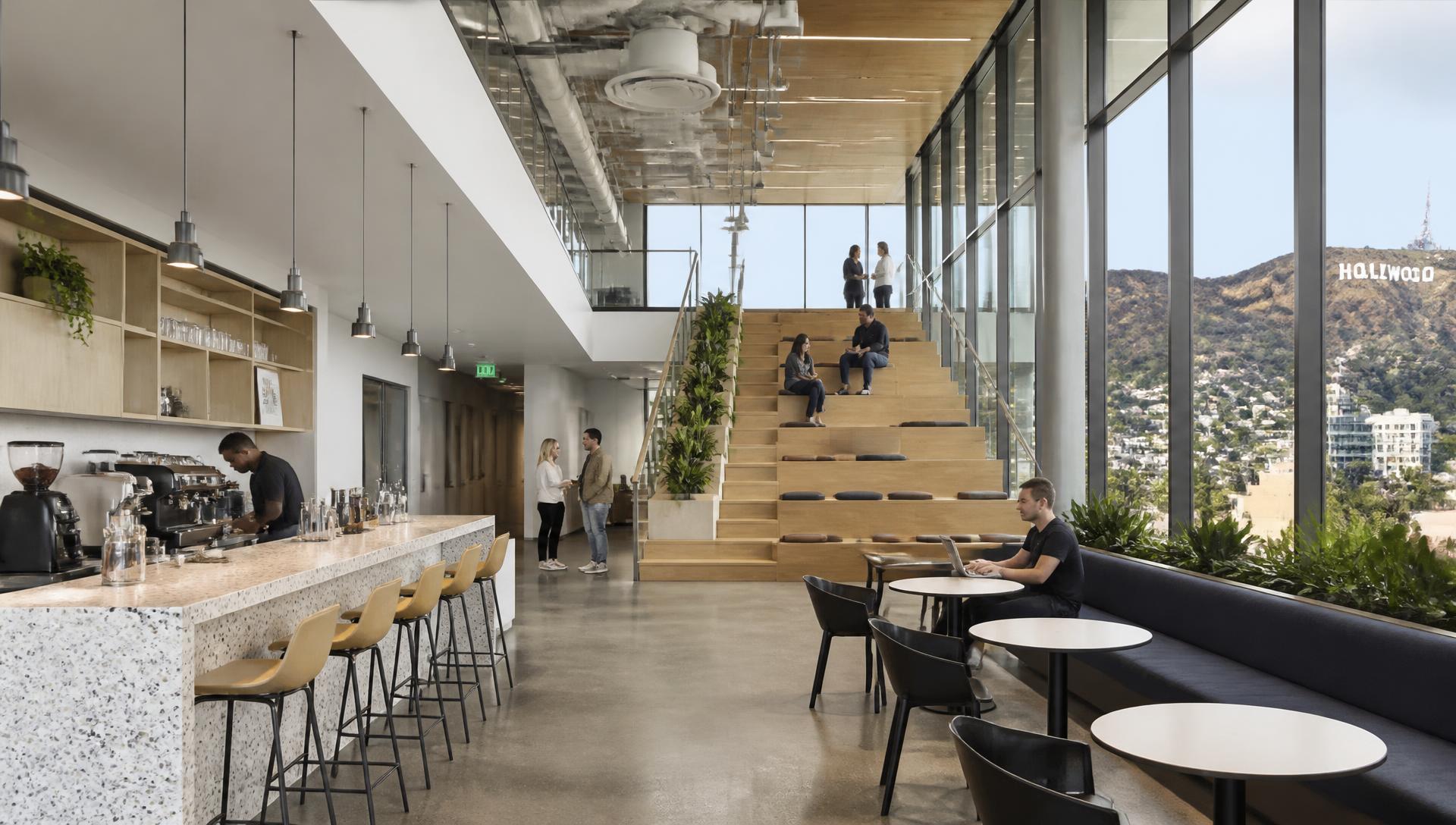 Tenant café & town-hall stair · Hollywood sign through the glass