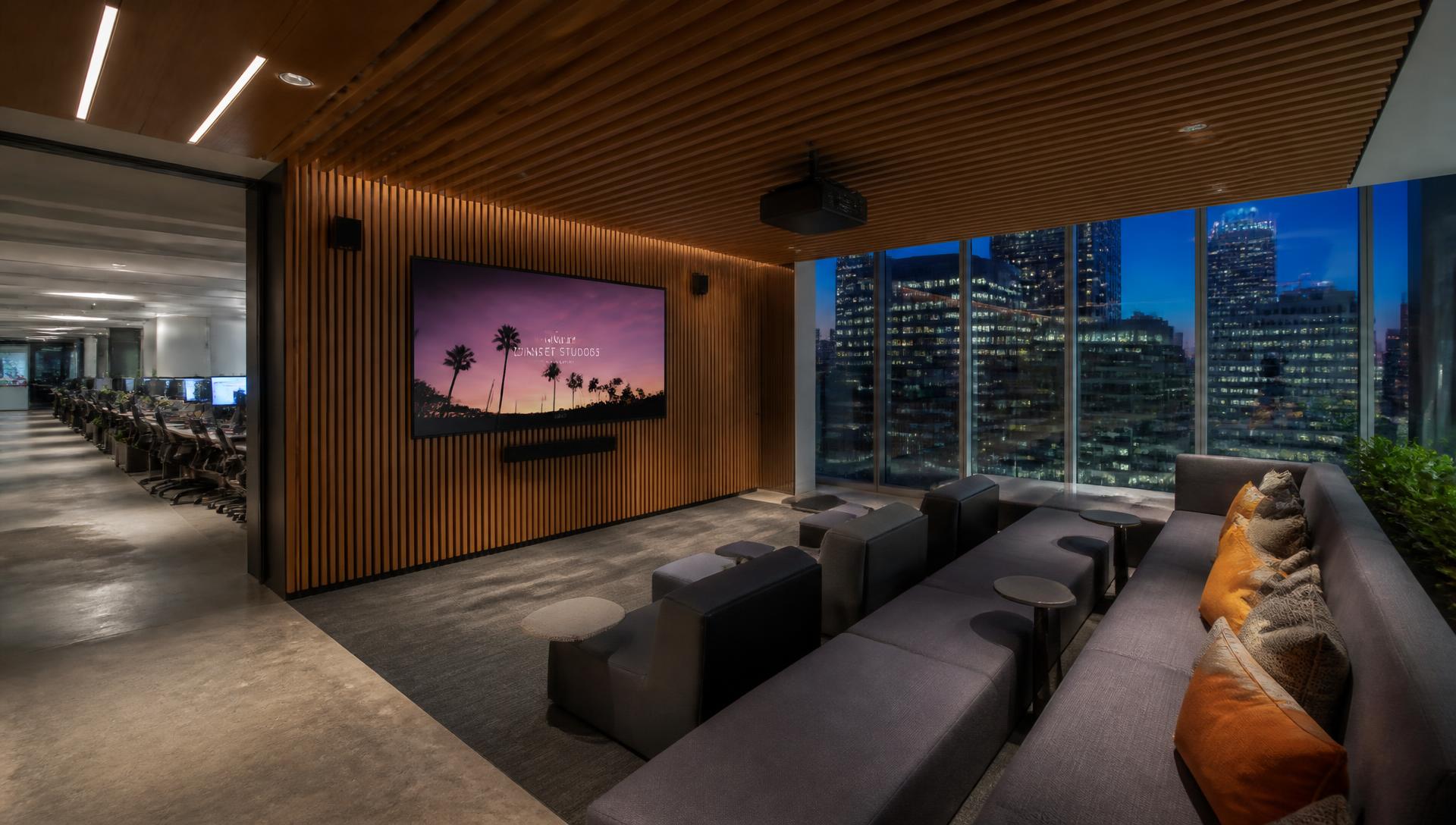 Media tenant screening room · blue-hour city light beyond